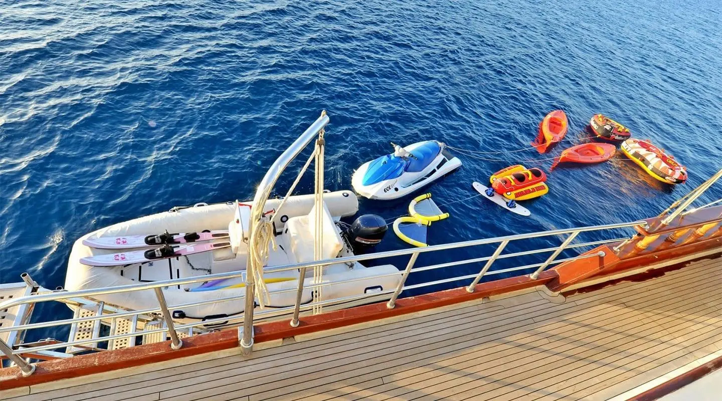 Yacht Berrak Su docked at sunset with railing and lifebuoys on deck