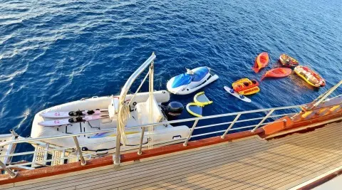 Yacht Berrak Su docked at sunset with railing and lifebuoys on deck