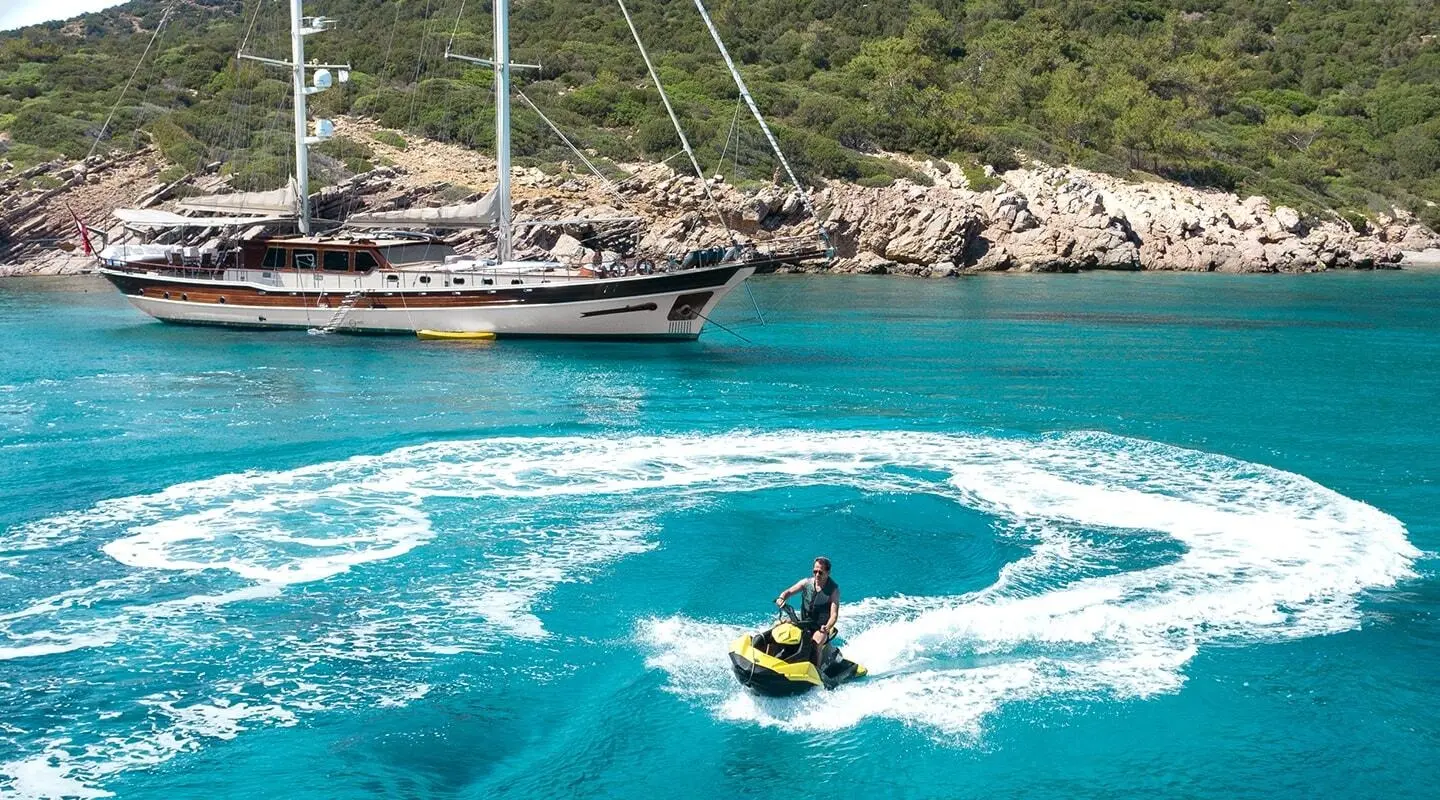 Estrella De Mar yacht anchored near rocky coastline with turquoise water