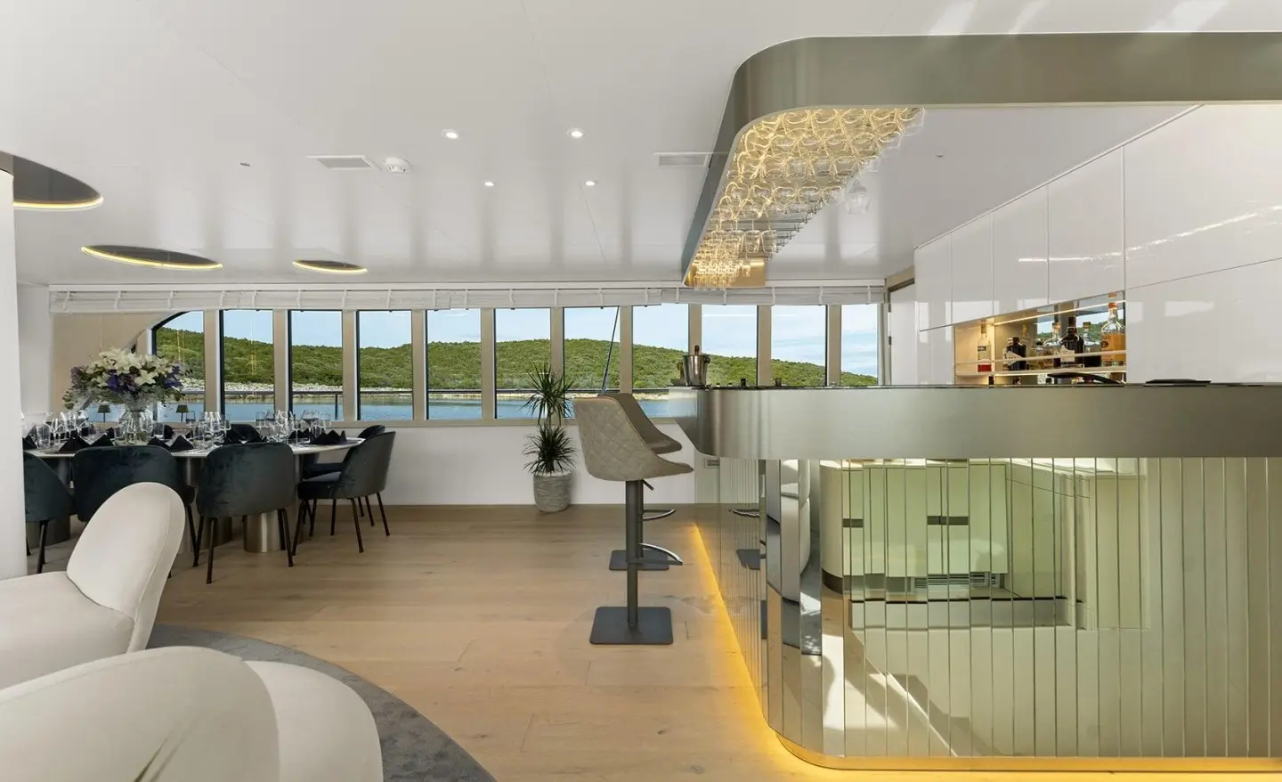 Maxita luxury yacht salon and dining area with seating, lighting, and windows