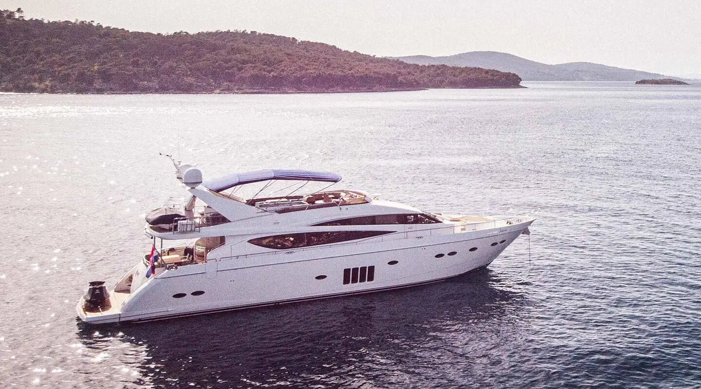 Insieme motor yacht anchored on calm water