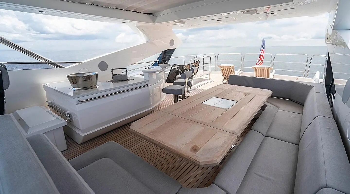 Quantum yacht flybridge, open deck with wooden table and seating area visible