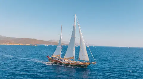 La Bella Vita sailing yacht under full white sails on blue sea