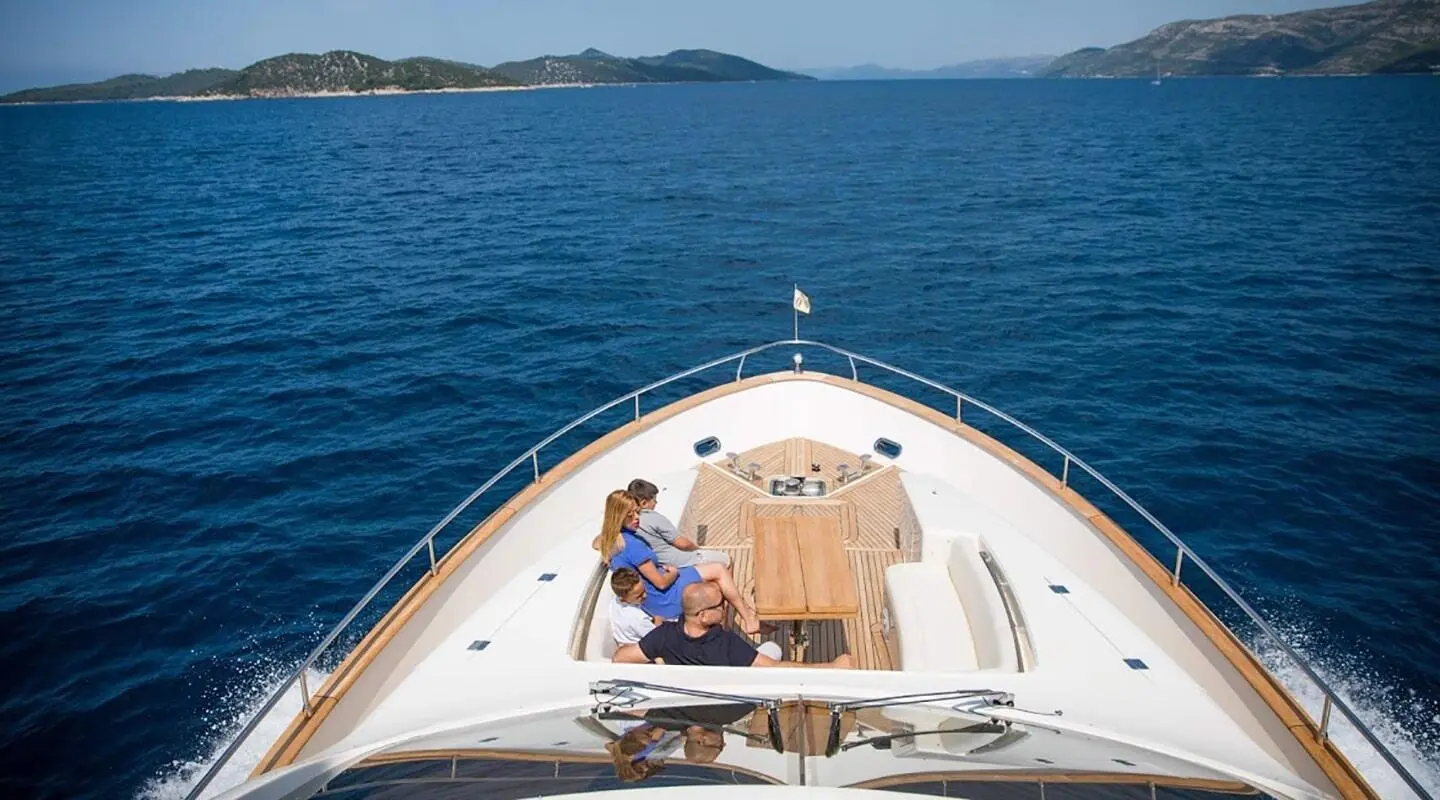 From bow view aboard Salt yacht, two people lounge on deck at sunrise