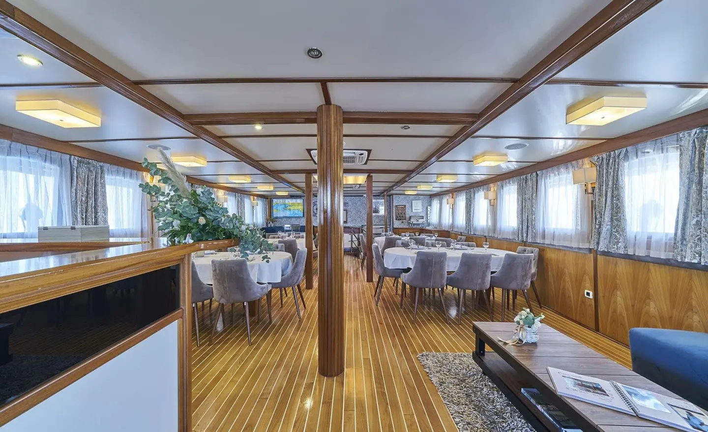 Amorena motor yacht saloon interior with wooden floors and seating