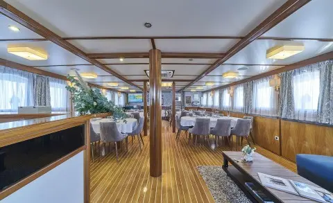 Amorena motor yacht saloon interior with wooden floors and seating