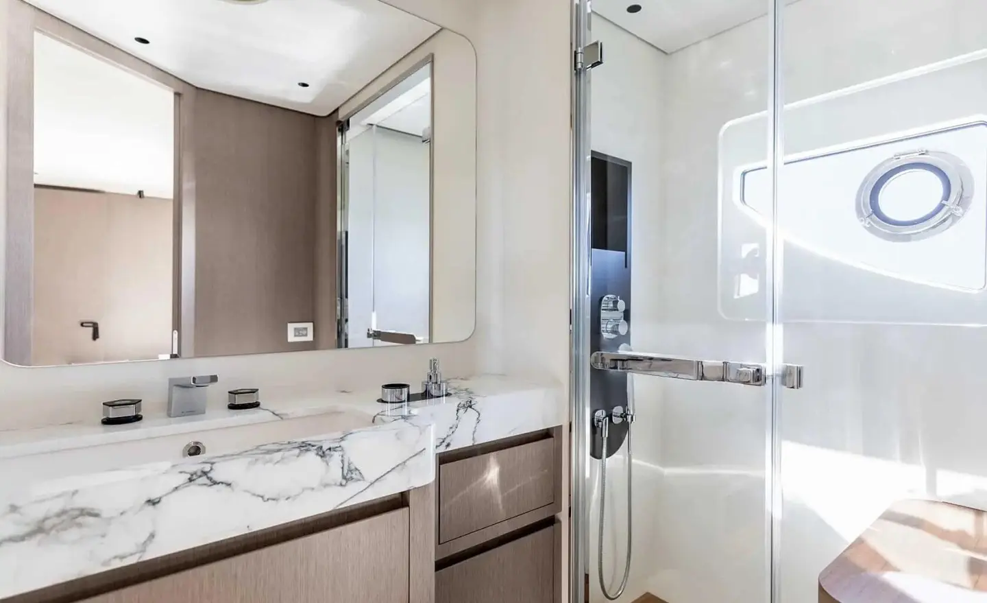 Viva II yacht bathroom with sink, mirror, and glass shower enclosure
