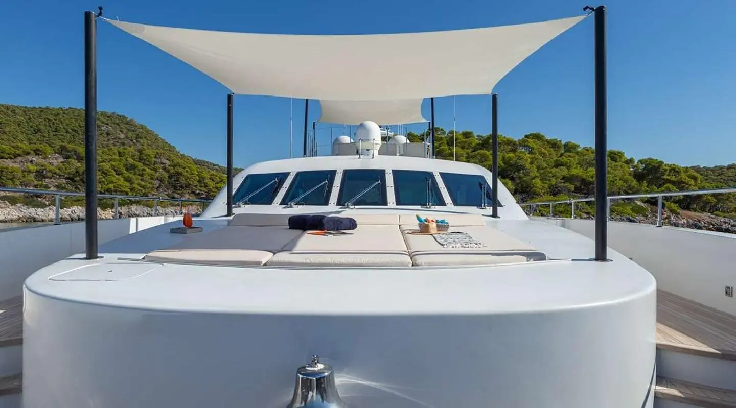 Sea Wolf luxury yacht anchored with sunlit white hull under blue sky