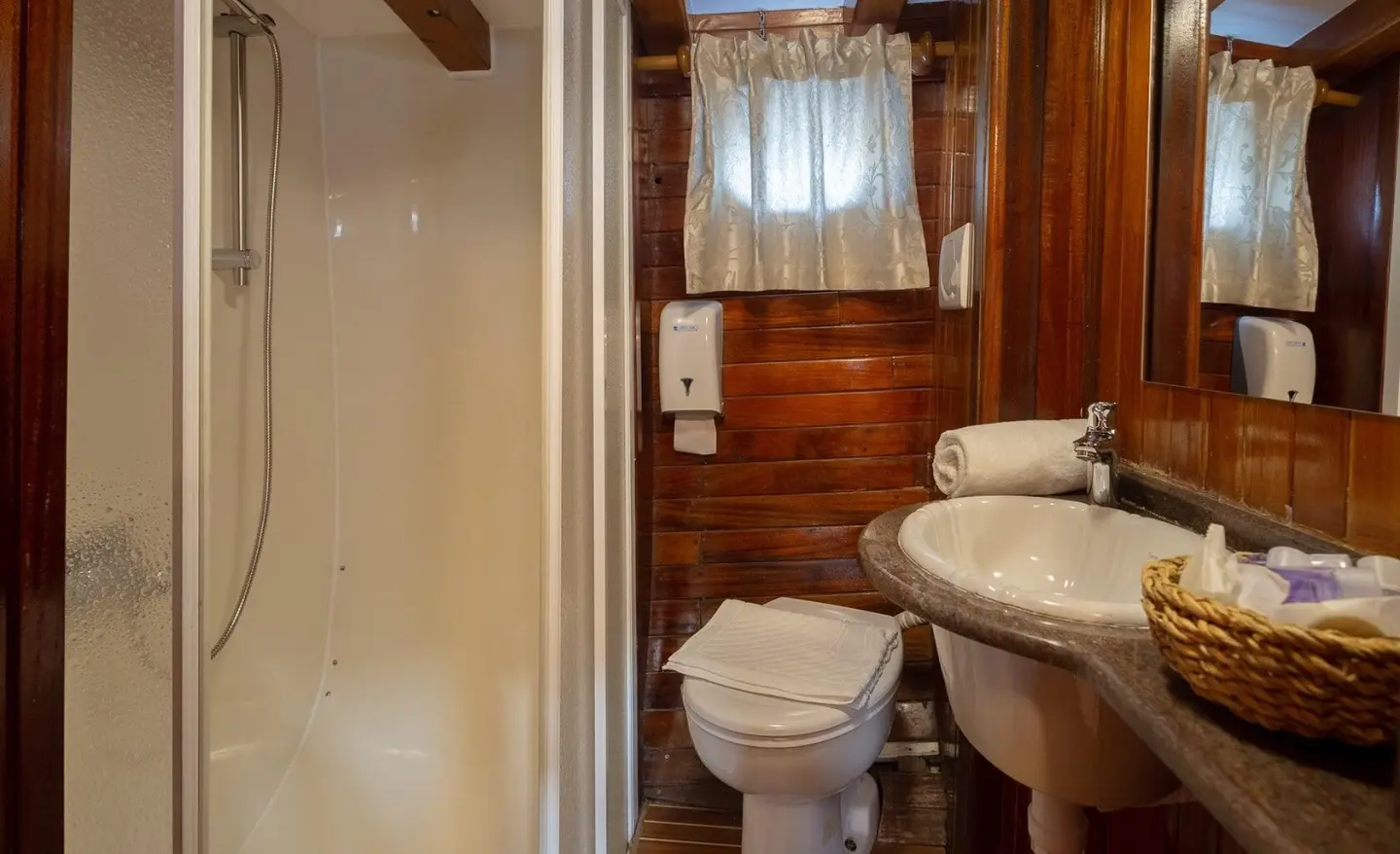 Andi Star yacht interior bathroom with wooden paneling and window view
