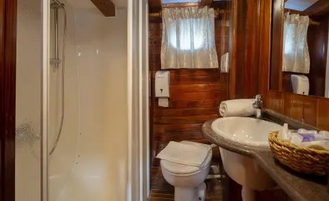 Andi Star yacht interior bathroom with wooden paneling and window view