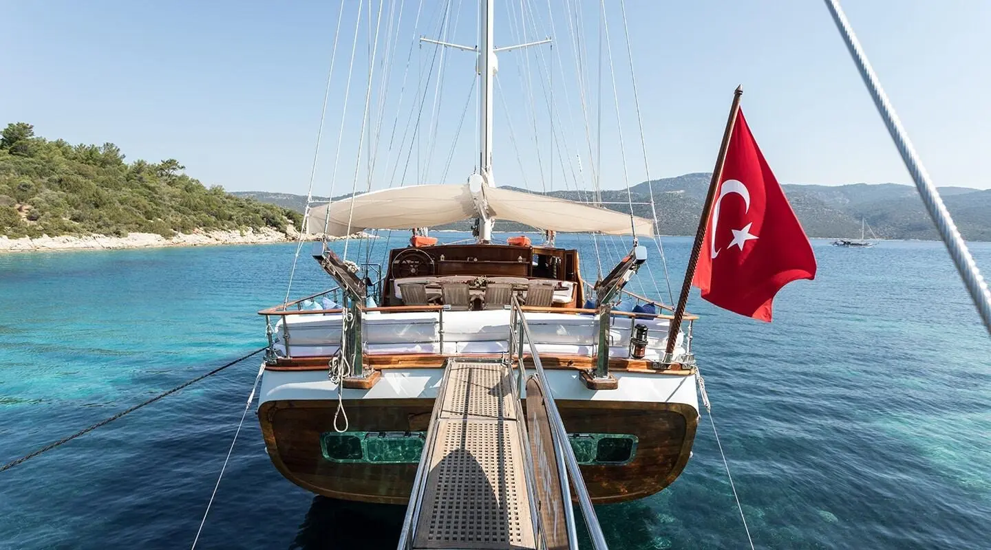 Grace 1 gulet at the dock with stern view and Turkish flag