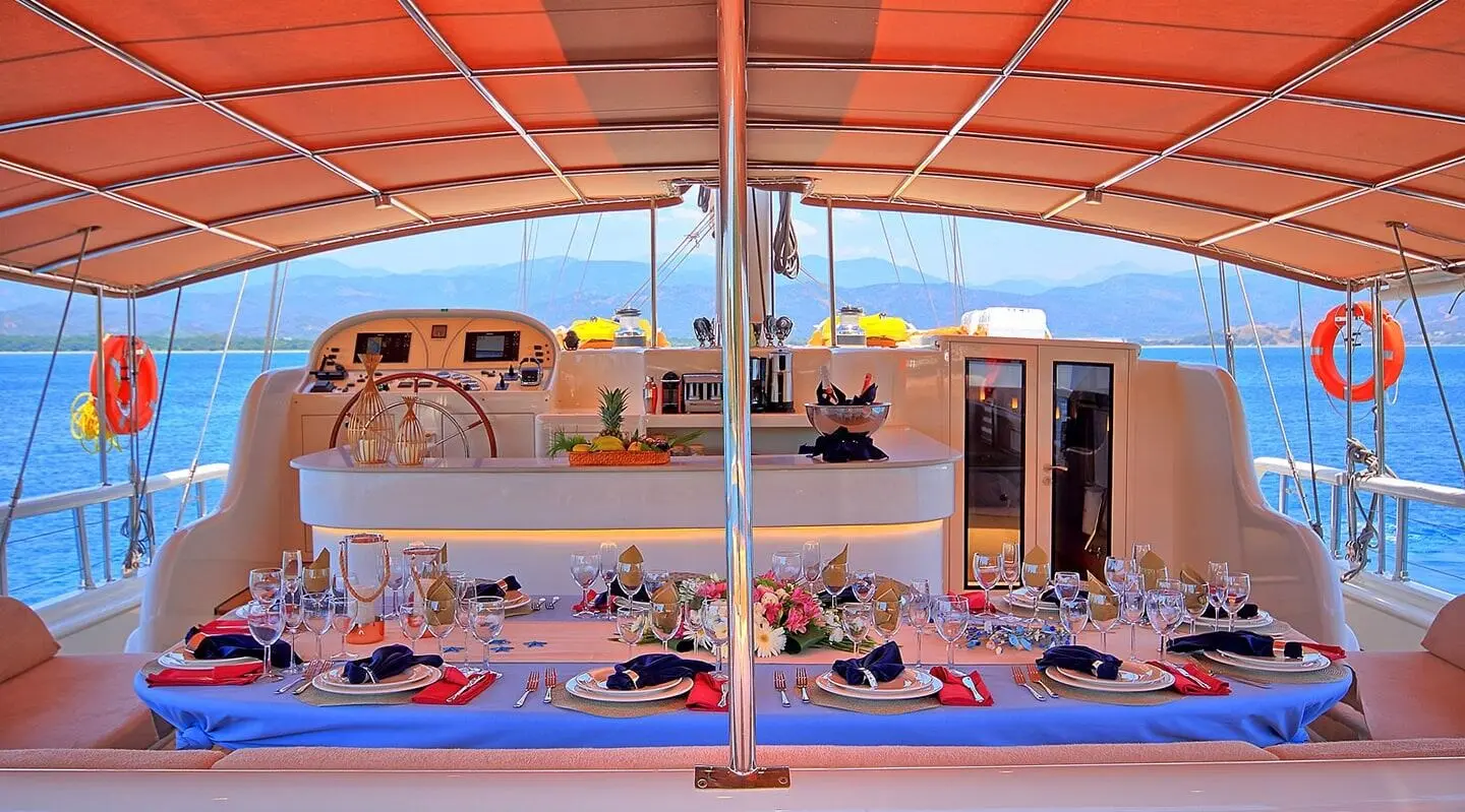Sunset dining on a luxurious yacht with a dining table and sea view