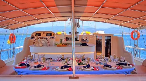 Sunset dining on a luxurious yacht with a dining table and sea view