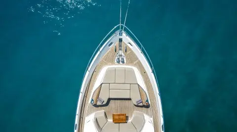 Vista motor yacht bow deck with seating area overlooking blue water