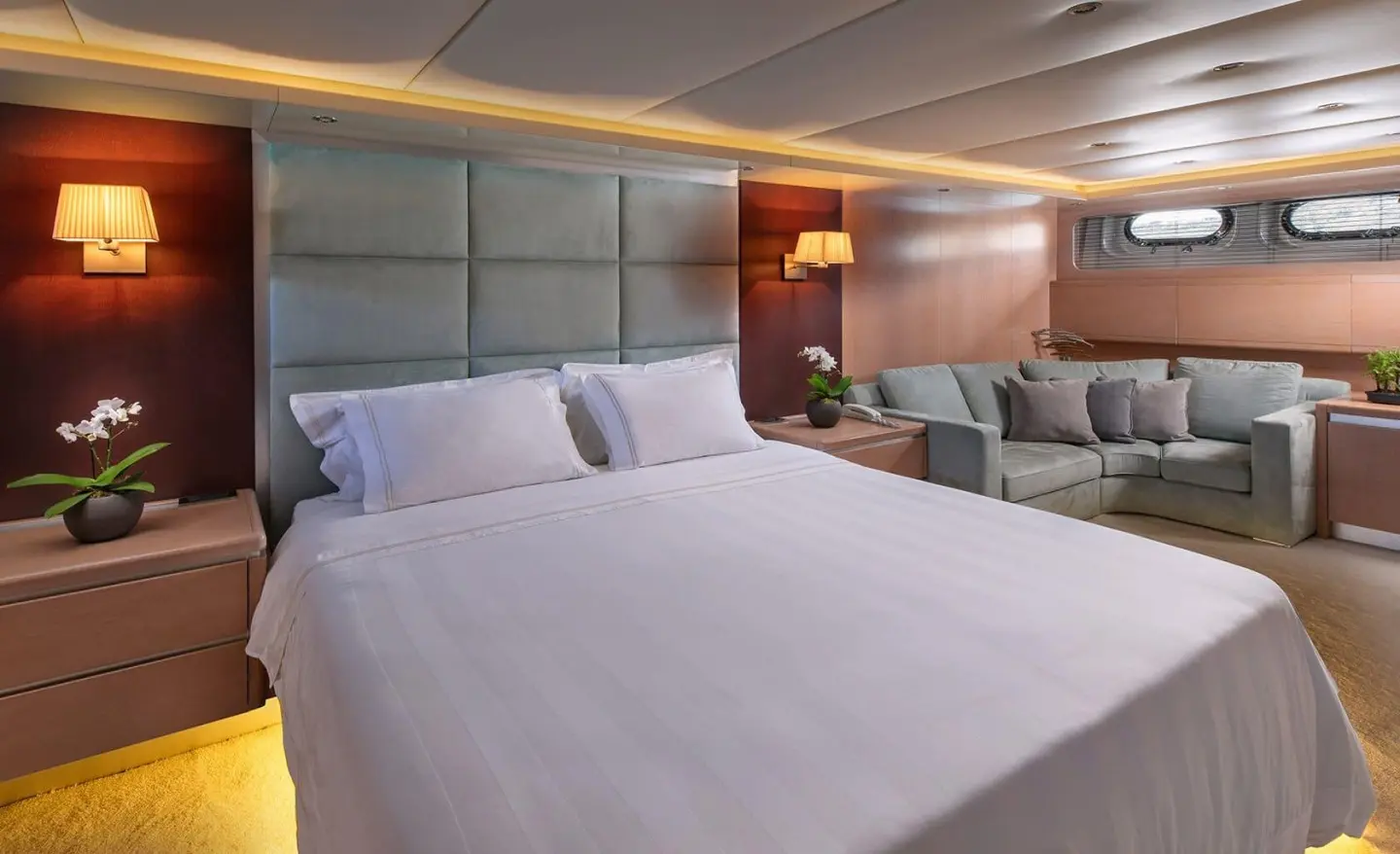 Luxurious yacht Magix cabin with large bed, pillows, and soft lighting