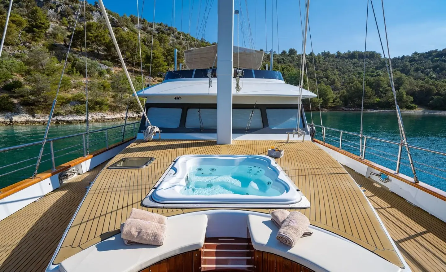Navilux yacht deck with a hot tub, sun loungers, and blue sea backdrop