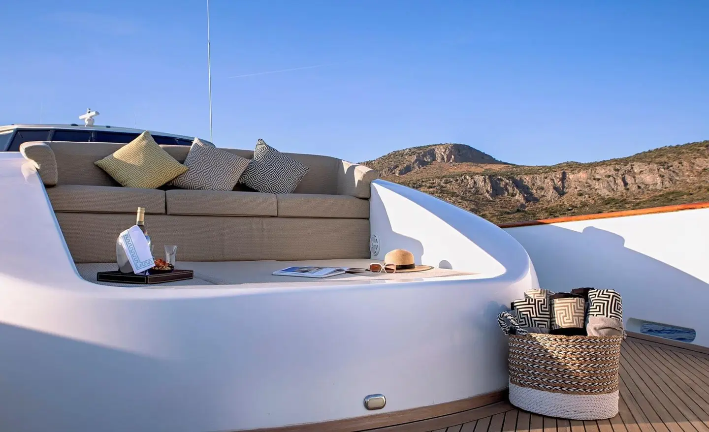 Aquila luxury yacht deck with white seating and blue sea in background