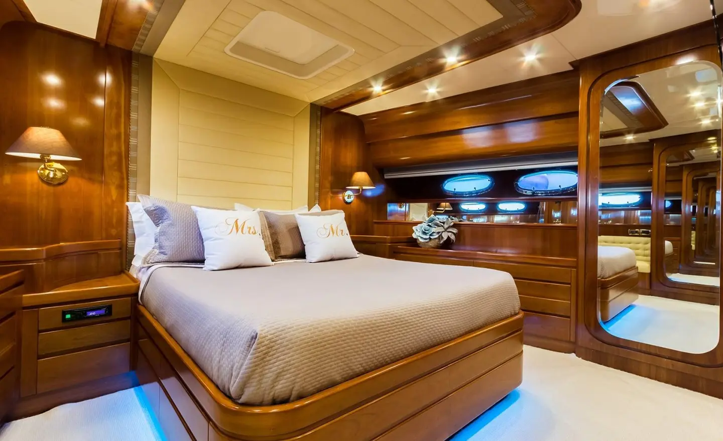 Amoraki yacht interior: double-bed cabin with wood paneling and blue accents