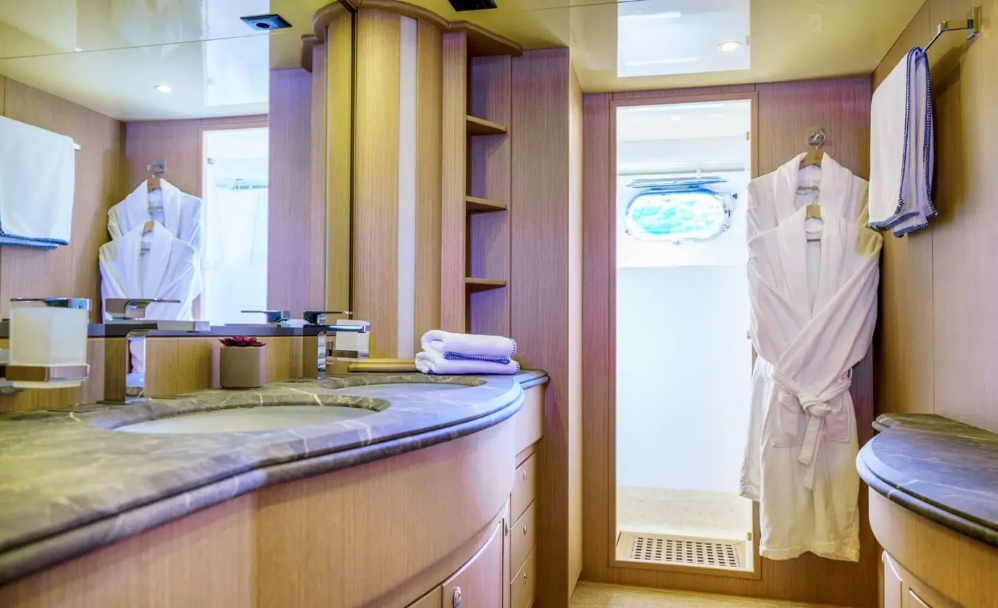Phantom yacht interior shows wood paneling, doorway, bed, and seating area