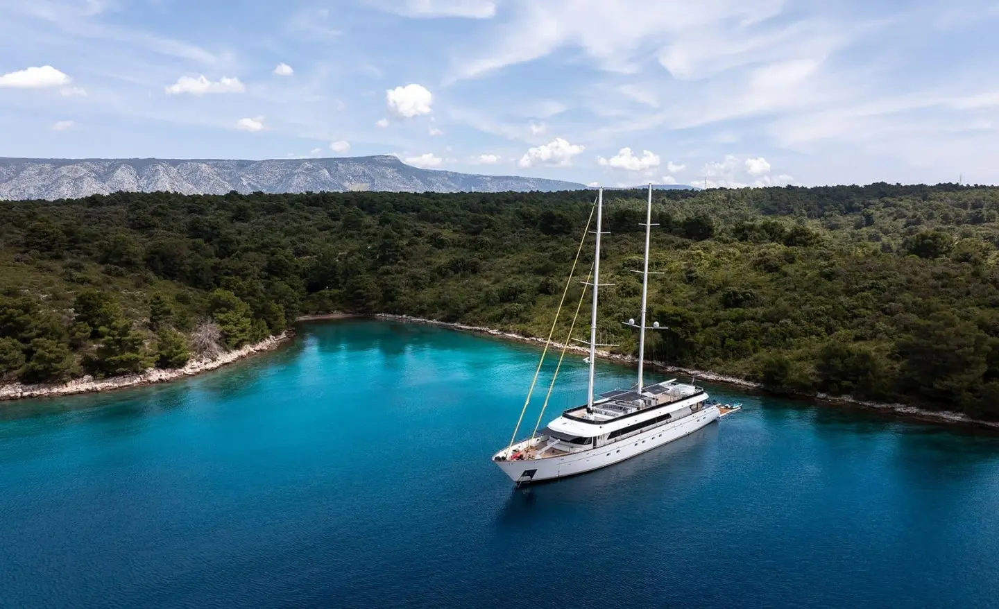 Anima Maris motor yacht anchored in a calm turquoise bay
