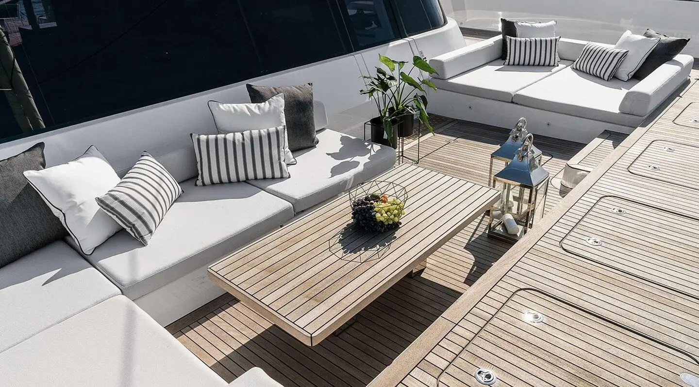 Above & Beyond luxury gulet sailing at sunset with deck seating and wooden table