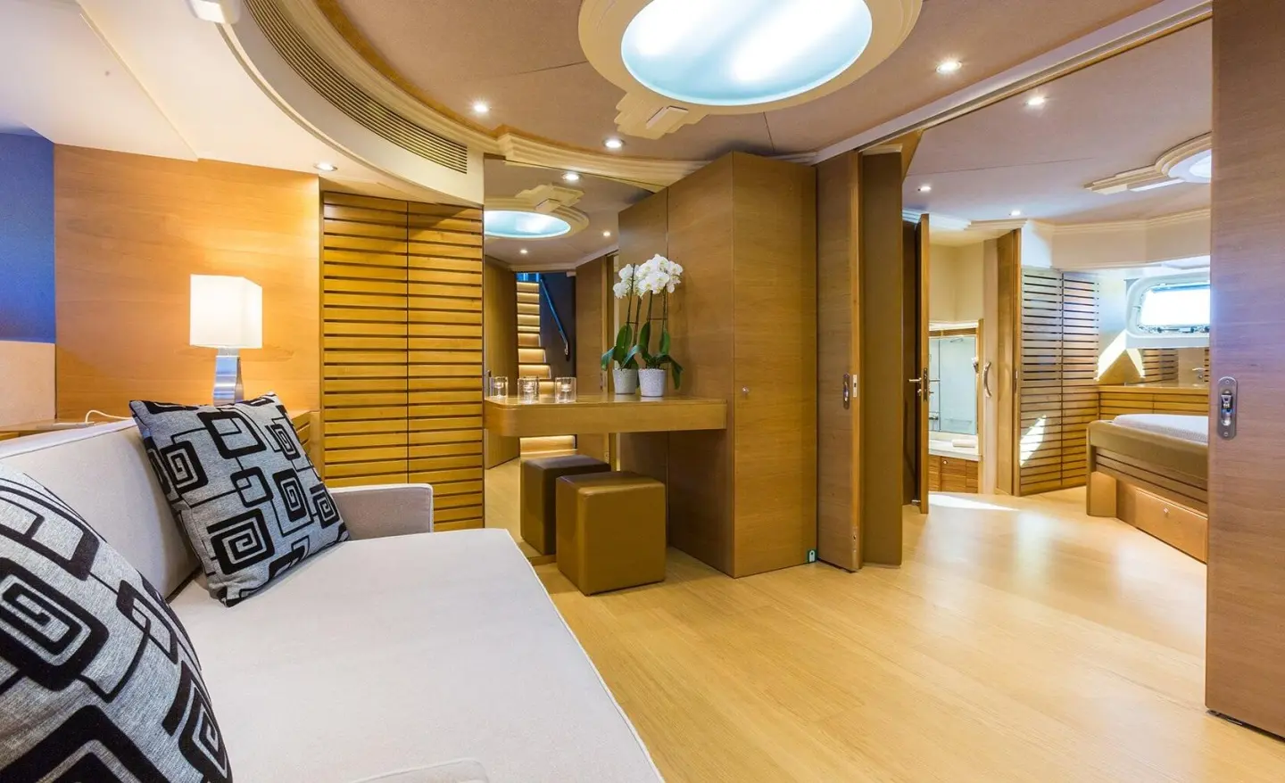 Interior cabin of Aquarella yacht with bed, wooden floor, and seating area