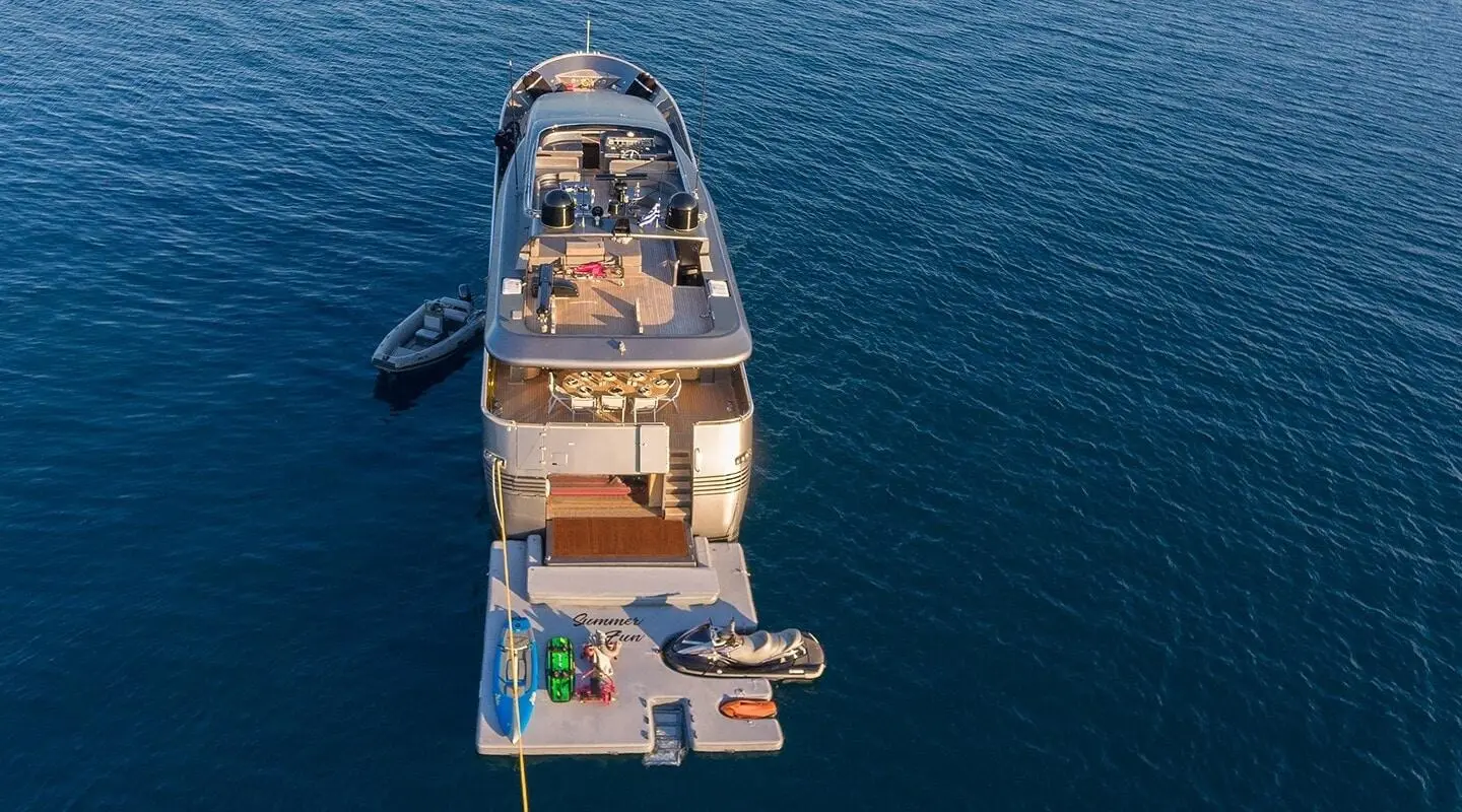Top-down view of Summer Fun yacht anchored in calm blue water with a swim platform