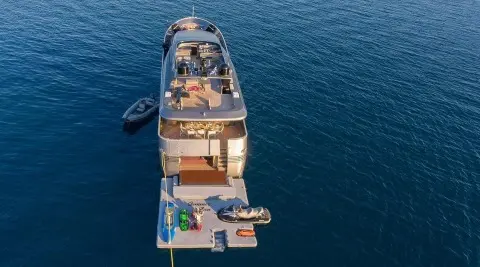 Top-down view of Summer Fun yacht anchored in calm blue water with a swim platform