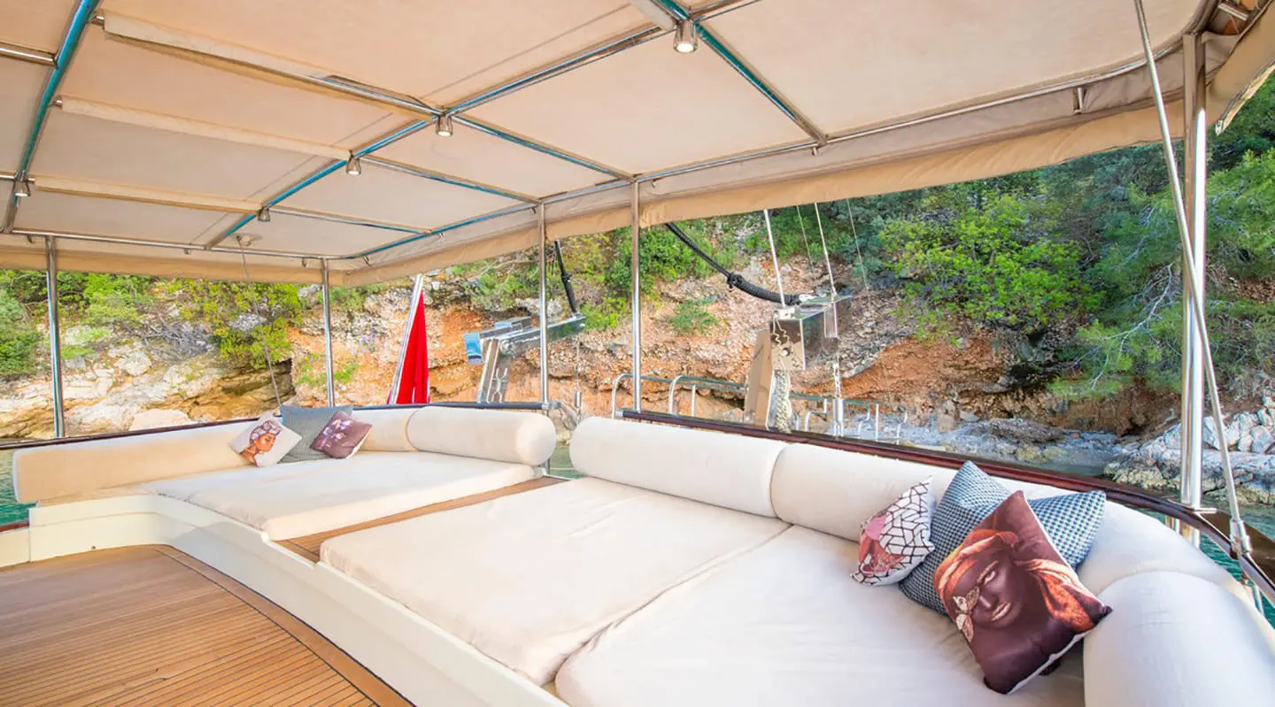 Mein Schatz yacht deck lounge under canopy with seating and cushions at sunset