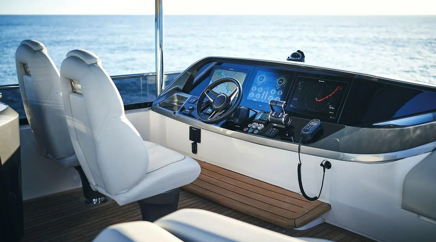 Flybridge of Elizabeth yacht with helm, seating, and ocean view