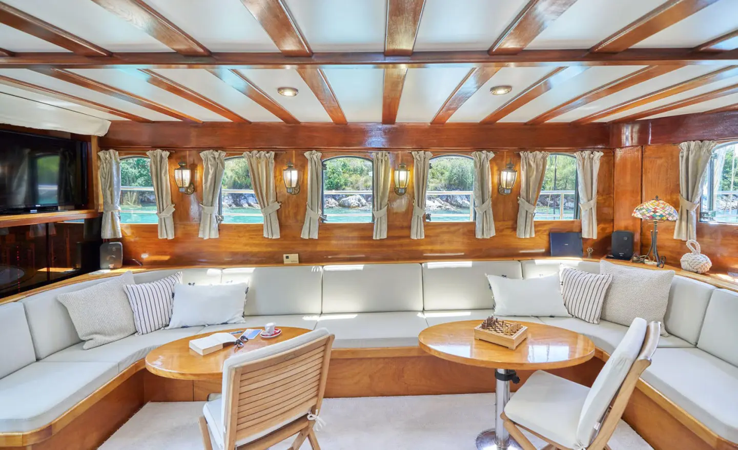 Luxurious yacht Libra interior with wooden ceiling beams and seating area