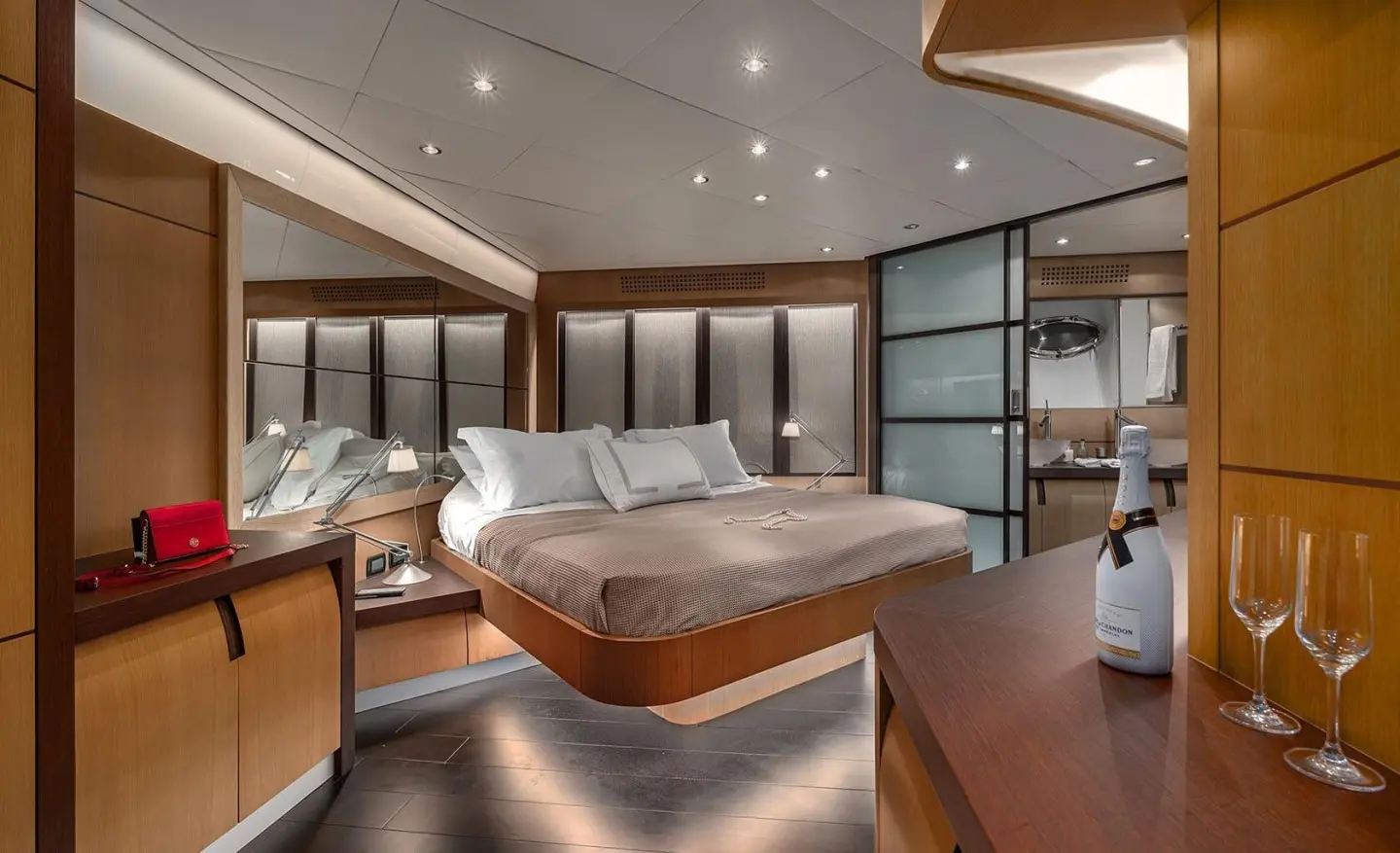 Motoryat One master cabin with large bed, wood flooring and illuminated ceiling