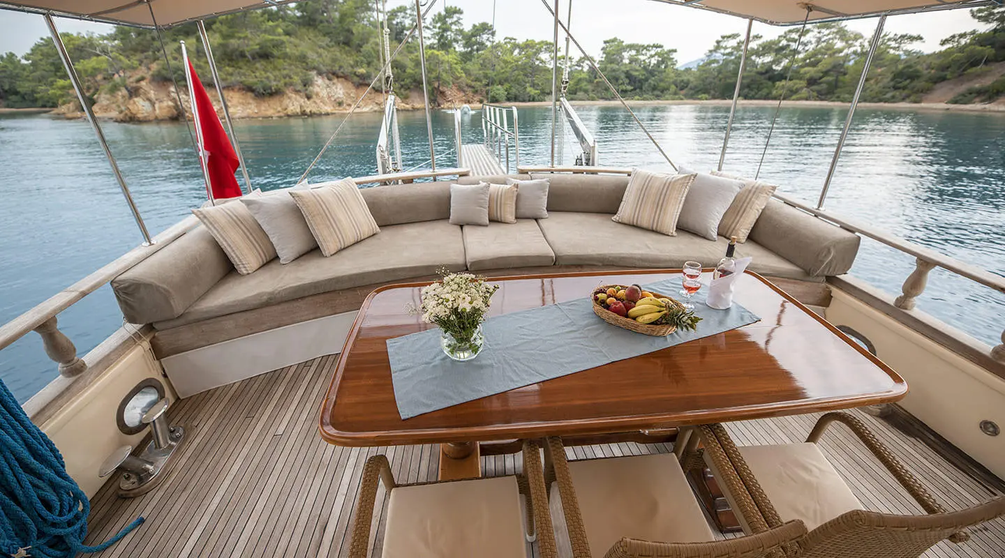 Aft deck seating on Gulet Faralya with wooden table and cushions