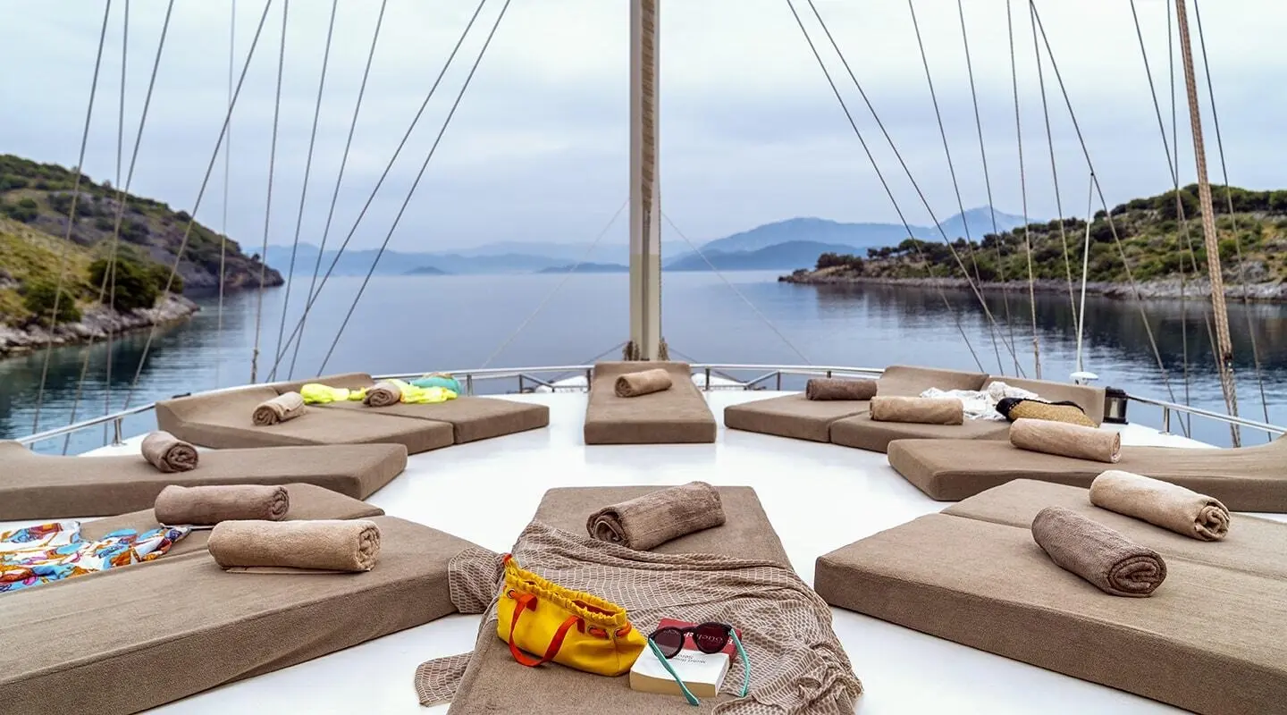 Tersane 8 luxury gulet bow with sun cushions facing calm blue sea at sunset