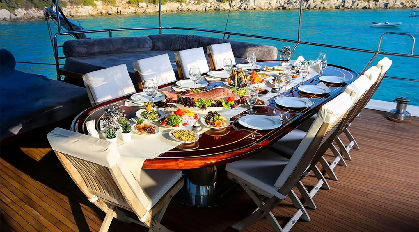 Diva Deniz yacht dining table set for sunset aboard a luxury gulet