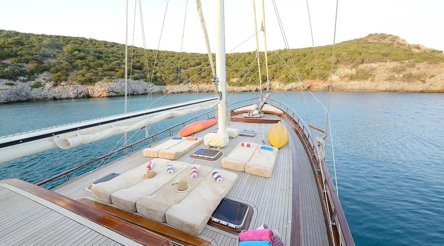 Open deck of a gulet with beige cushions and life jackets on a luxury yacht