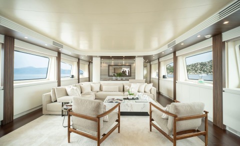 Pareaki II saloon with white sofas and wood-framed chairs in a luxurious interior