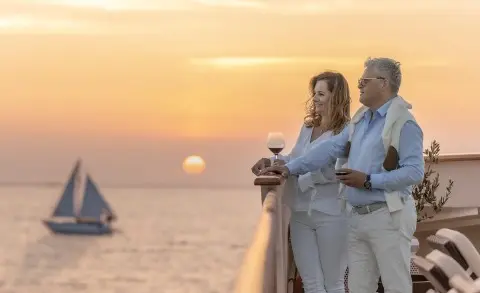Karizma motor yacht at sunset in calm harbor with purple sky