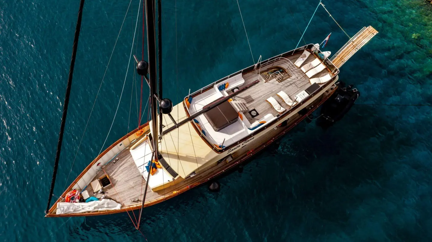 Top-down view of a wooden yacht anchored in turquoise water, Santa Clara