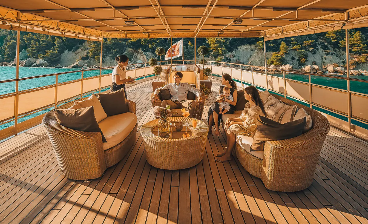 Seagull II yacht on the open deck with a group of people chatting