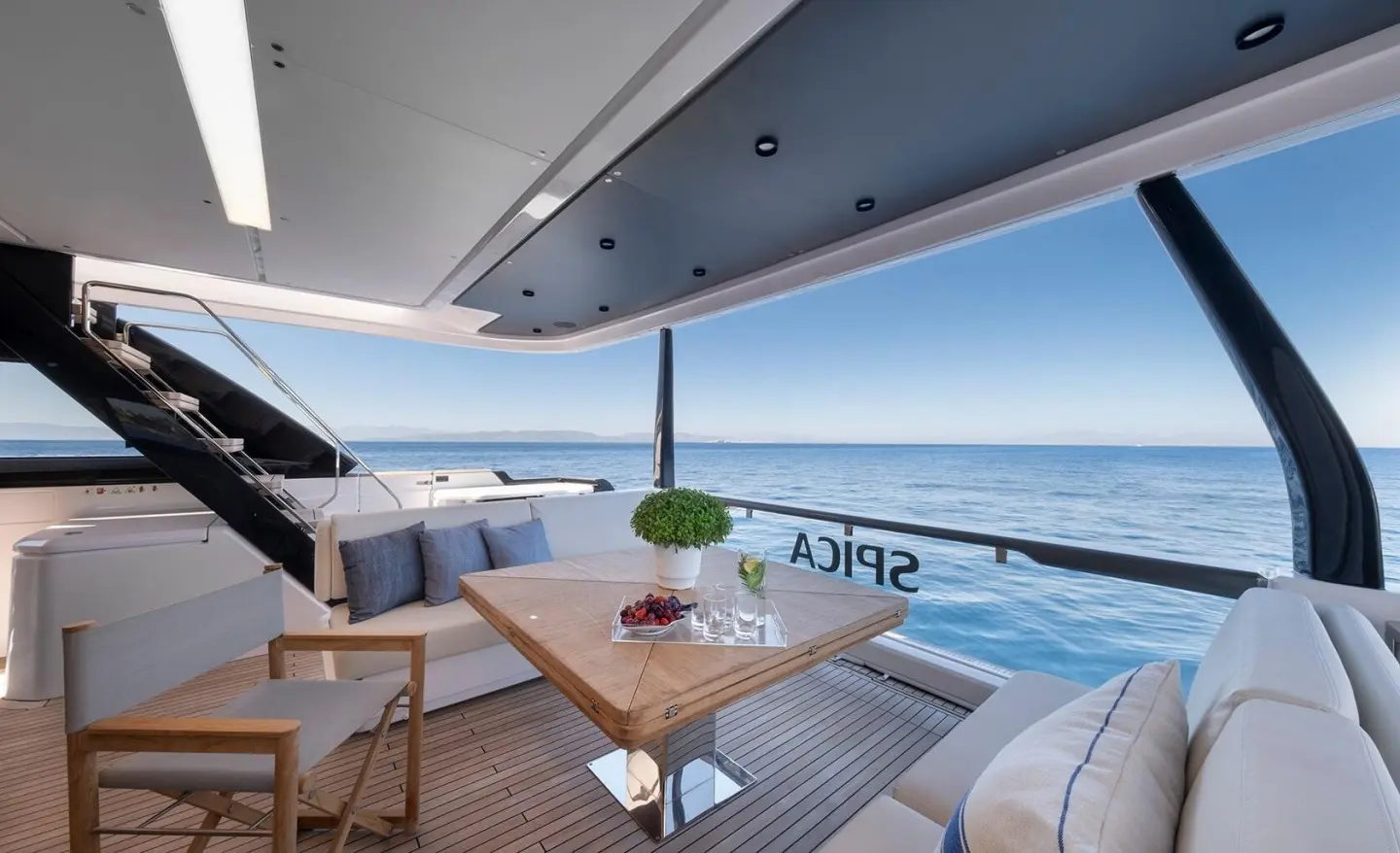 Spica yacht deck at sunset with seating area and ocean view