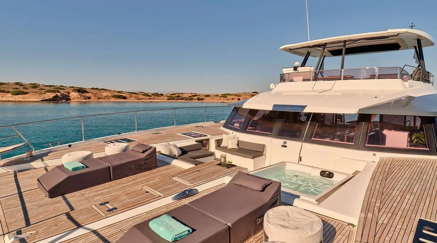 Christal Mio yacht deck with sun loungers, teak finish, and clear blue sea
