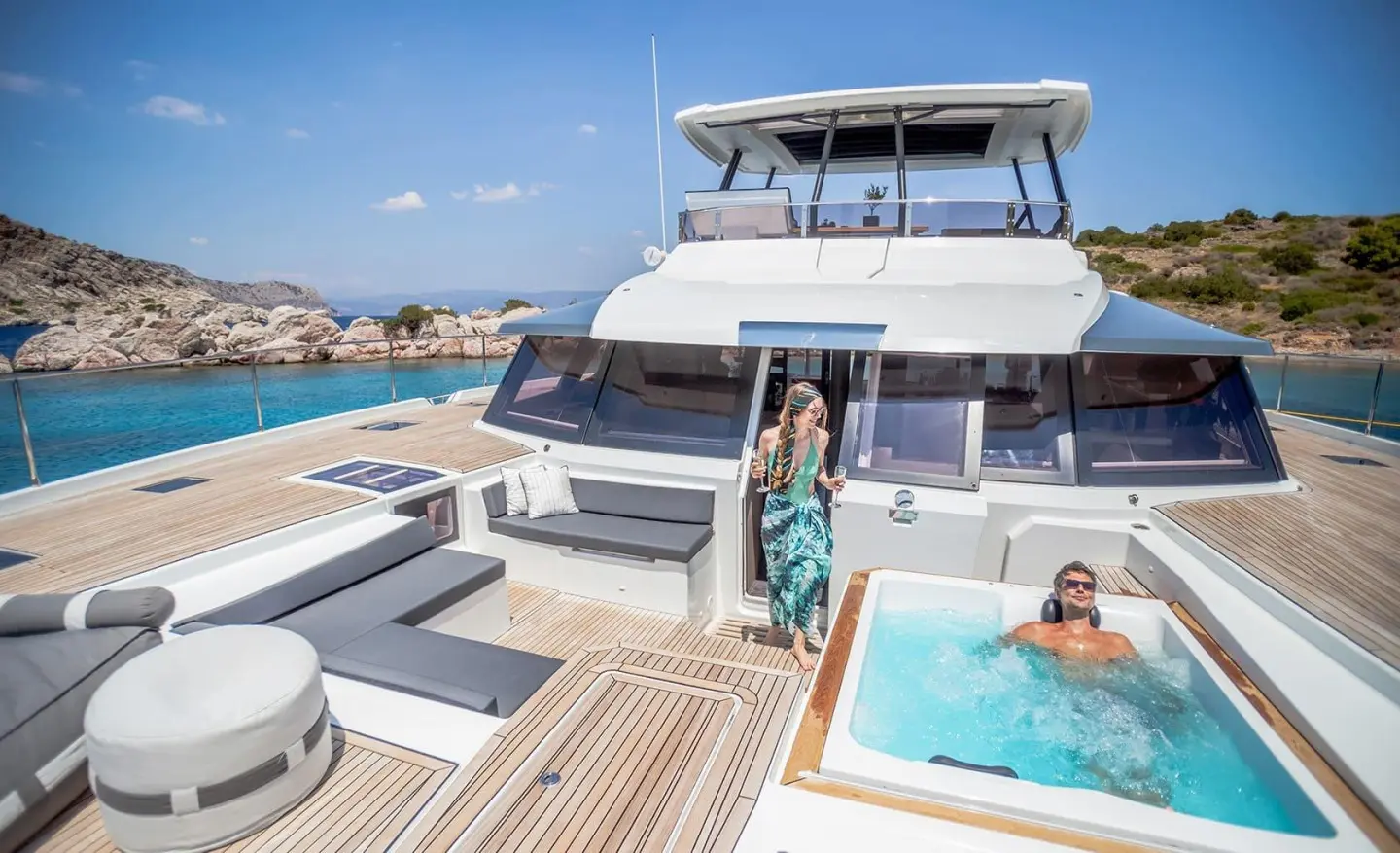 Yacht D2 bow deck with sun loungers and a small pool on a sunny day