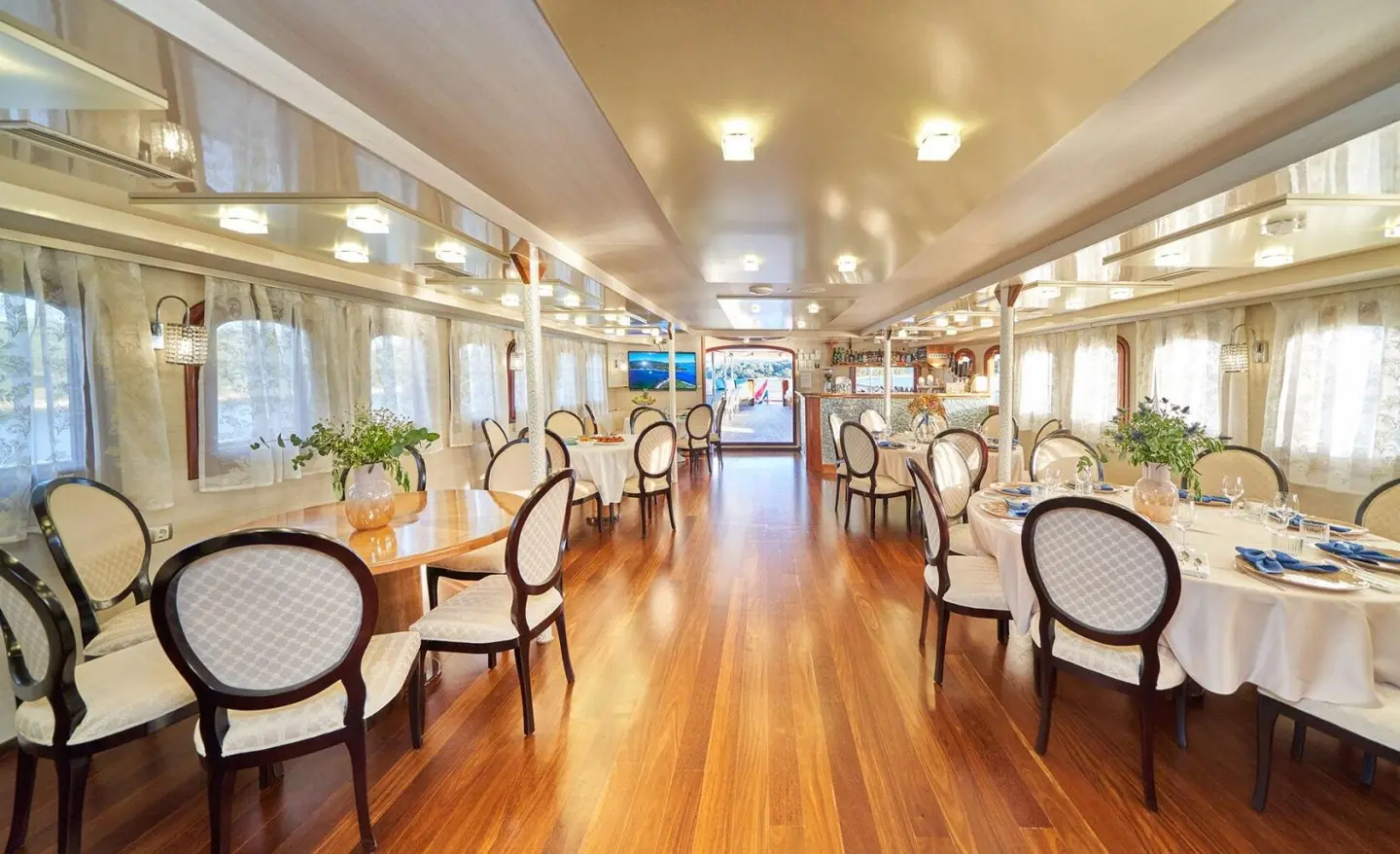 Spacious salon aboard Casablanca yacht with wooden floors and seating