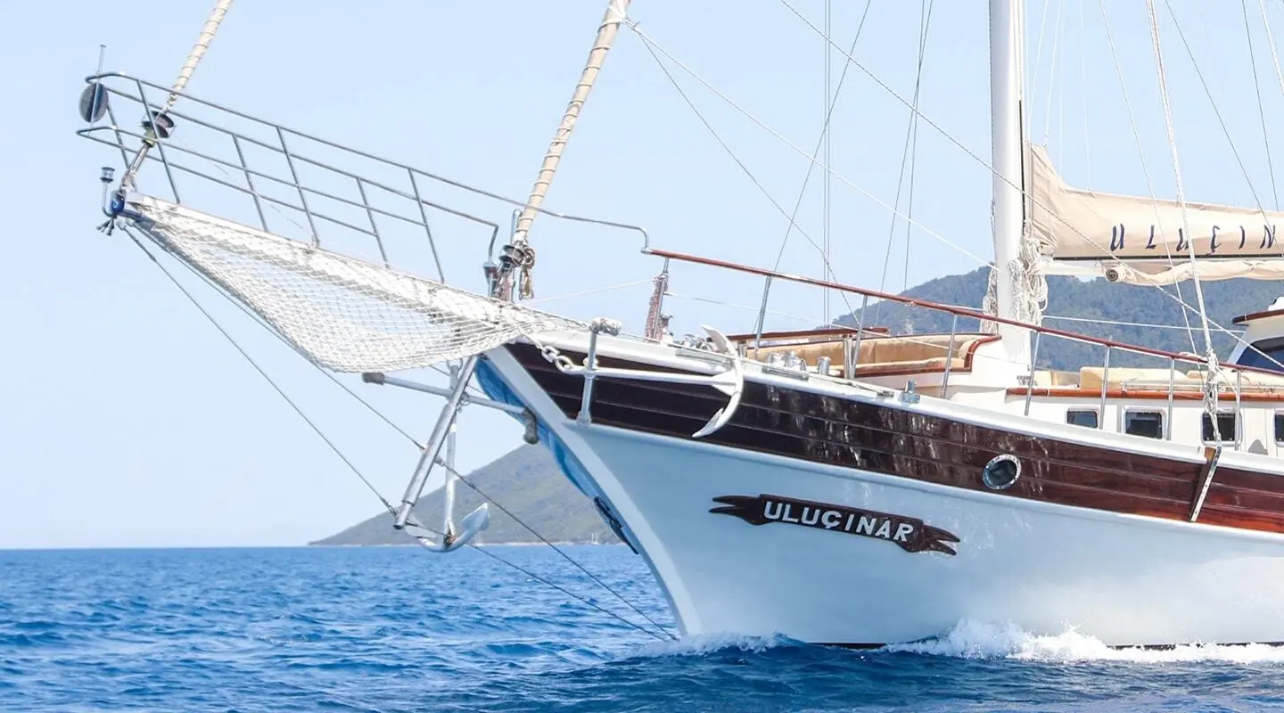 Yacht Ulucinar gulet sails at sea with bow close-up and rigging