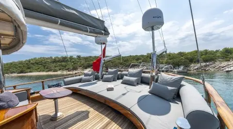 Yacht Bedia Sultan deck viewpoint with seating, white cushions, and calm blue sea