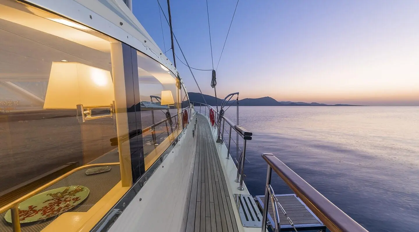 Sunset view from the yacht Queen Of Sea along its deck and railing
