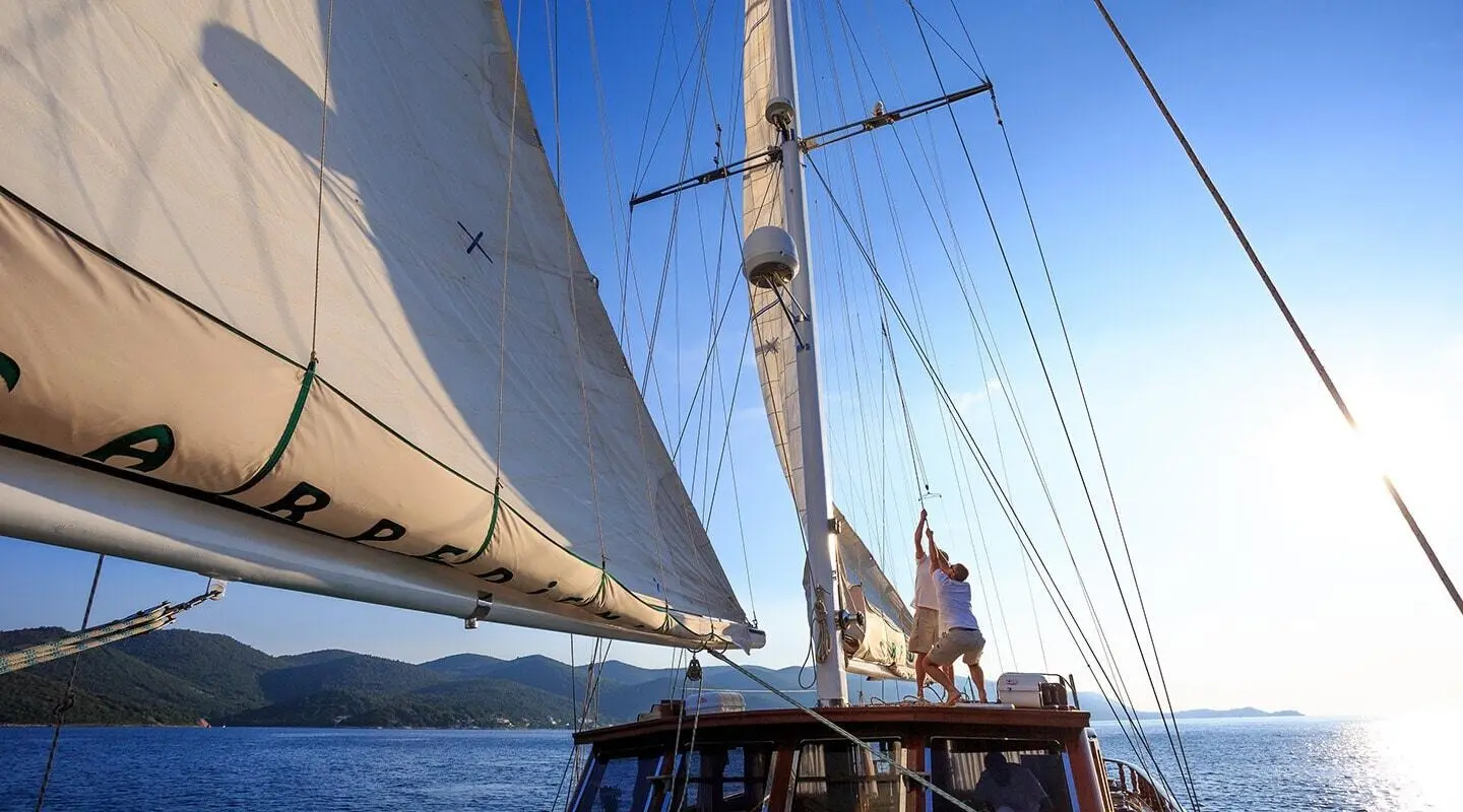 Gulet Carpe Diem 7 with sails on deck, in open sea