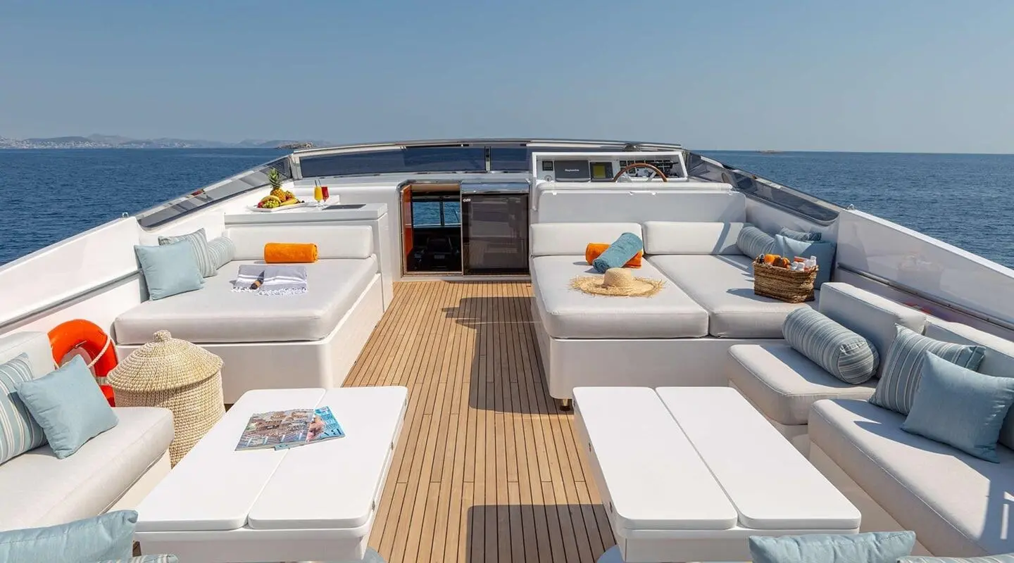 Grace yacht outer deck with white seating, sun cushions, and blue sea view