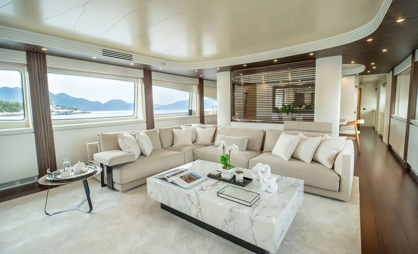 Pareaki II motor yacht saloon; large seating area and coffee table, bright interior